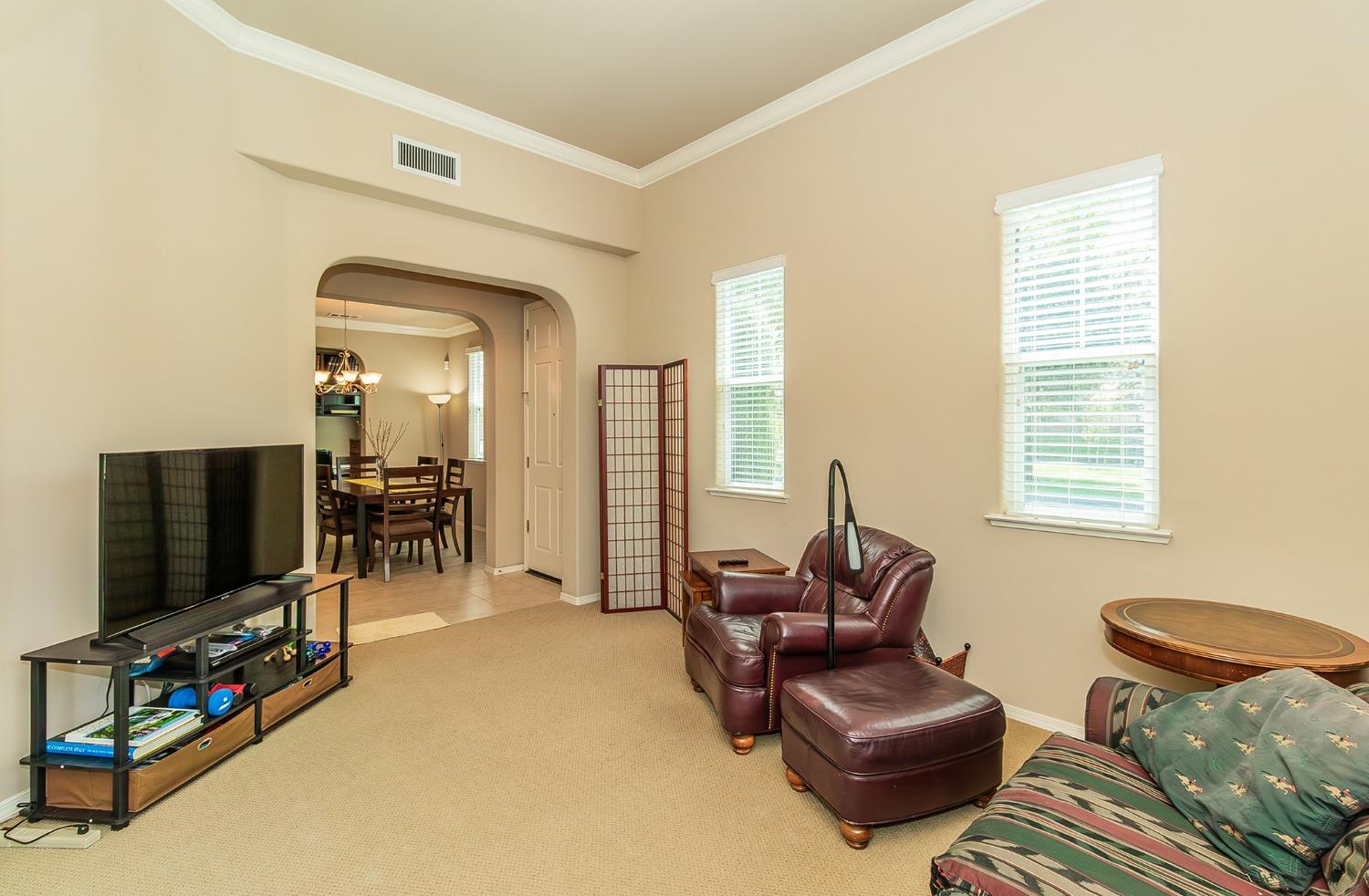 4179 Harlan Ranch Boulevard Clovis, CA 93619 - Photo 10 of 47 a living room with furniture and a flat screen tv