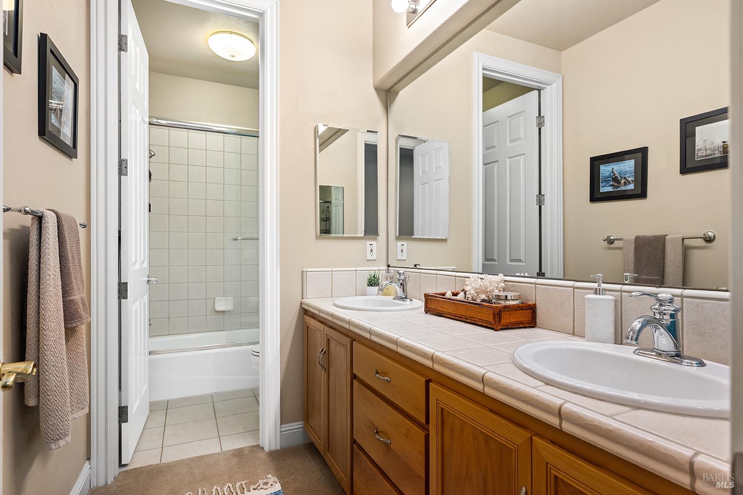 3696 Newbury Court Santa Rosa, CA 95404 - Photo 32 of 52 a bathroom with double vanity sink and a mirror