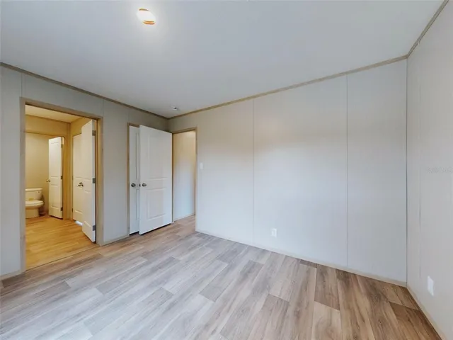 a view of hallway with wooden floor