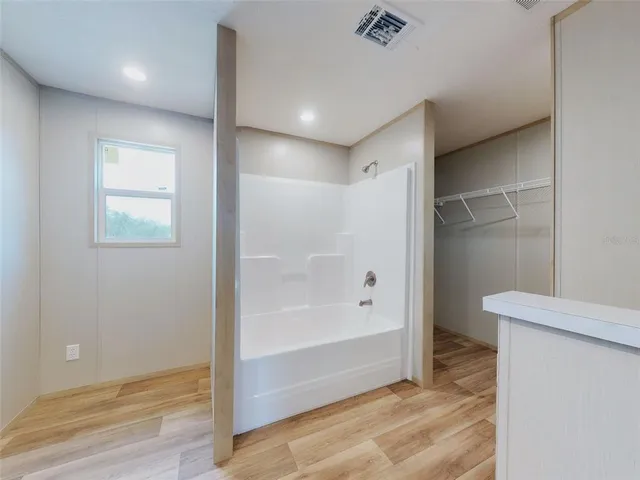 a bathroom with a glass shower door