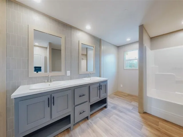 a bathroom with a double vanity sink and a mirror