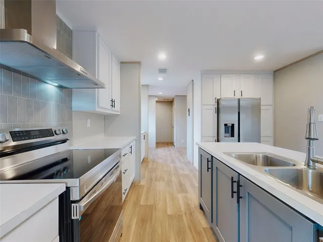 a kitchen with a sink and a refrigerator