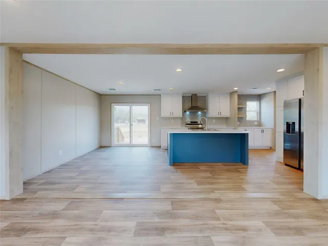 a view of kitchen with kitchen island sink and center island