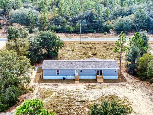 a view of a wooden fence and trees