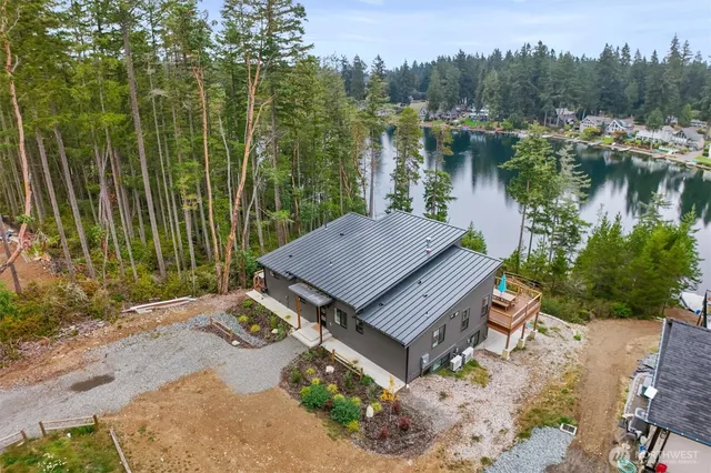an aerial view of a house with garden space and lake view