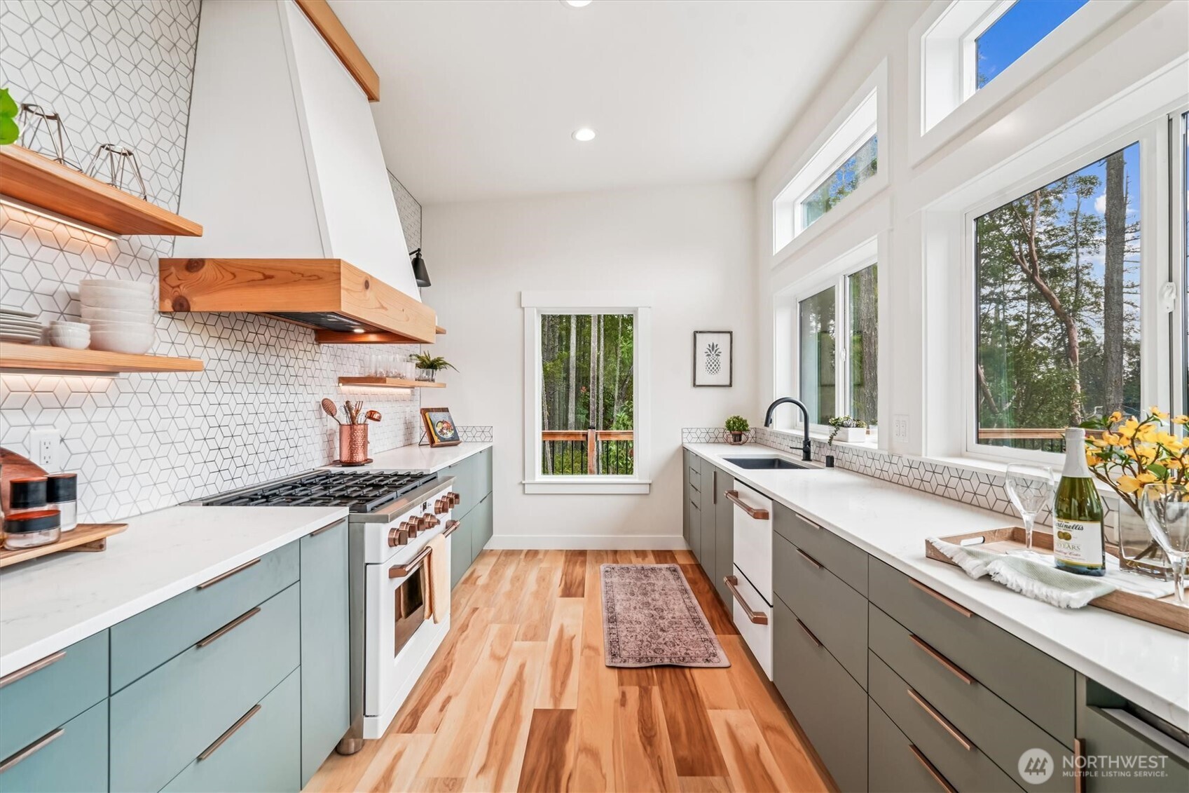 9705 117th Avenue Anderson Island, WA 98303 - Photo 16 of 40 a kitchen with stainless steel appliances a sink stove and cabinets