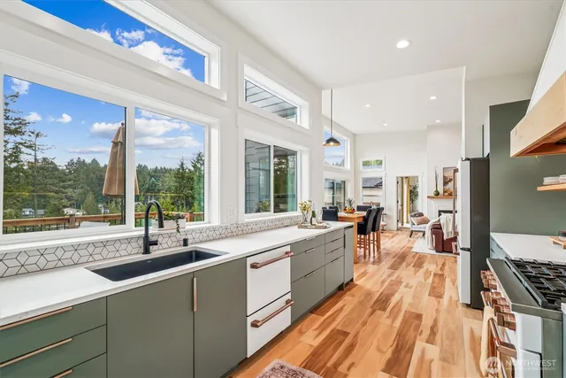 a large kitchen with stainless steel appliances a lot of counter space and a large window