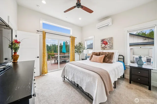 a spacious bedroom with a bed and a large window