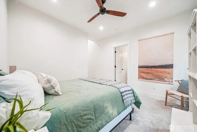 a bedroom with a bed window and couch