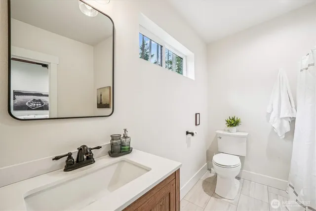 a bathroom with a toilet a sink and a mirror