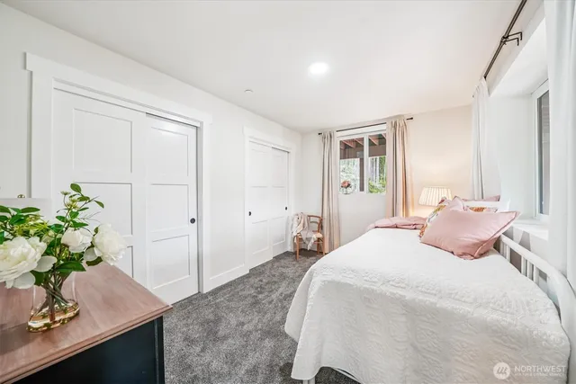 a bedroom with a bed and a large window