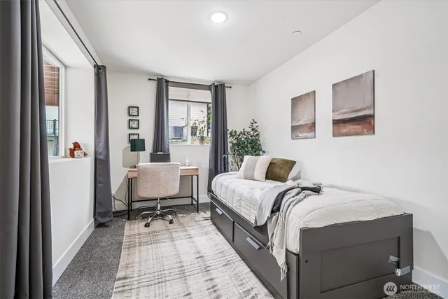 a bedroom with a bed and glass window