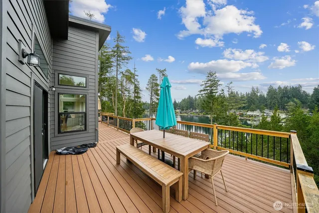 a view of a roof deck with wooden floor and fence