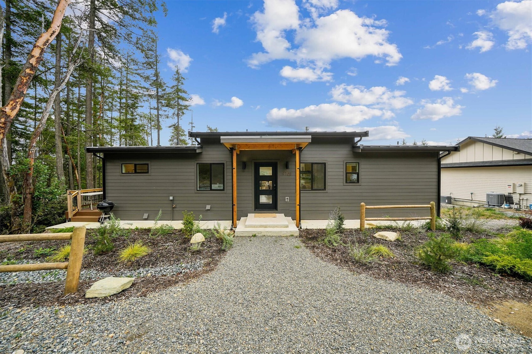 9705 117th Avenue Anderson Island, WA 98303 - Photo 8 of 40 a front view of a house with garden