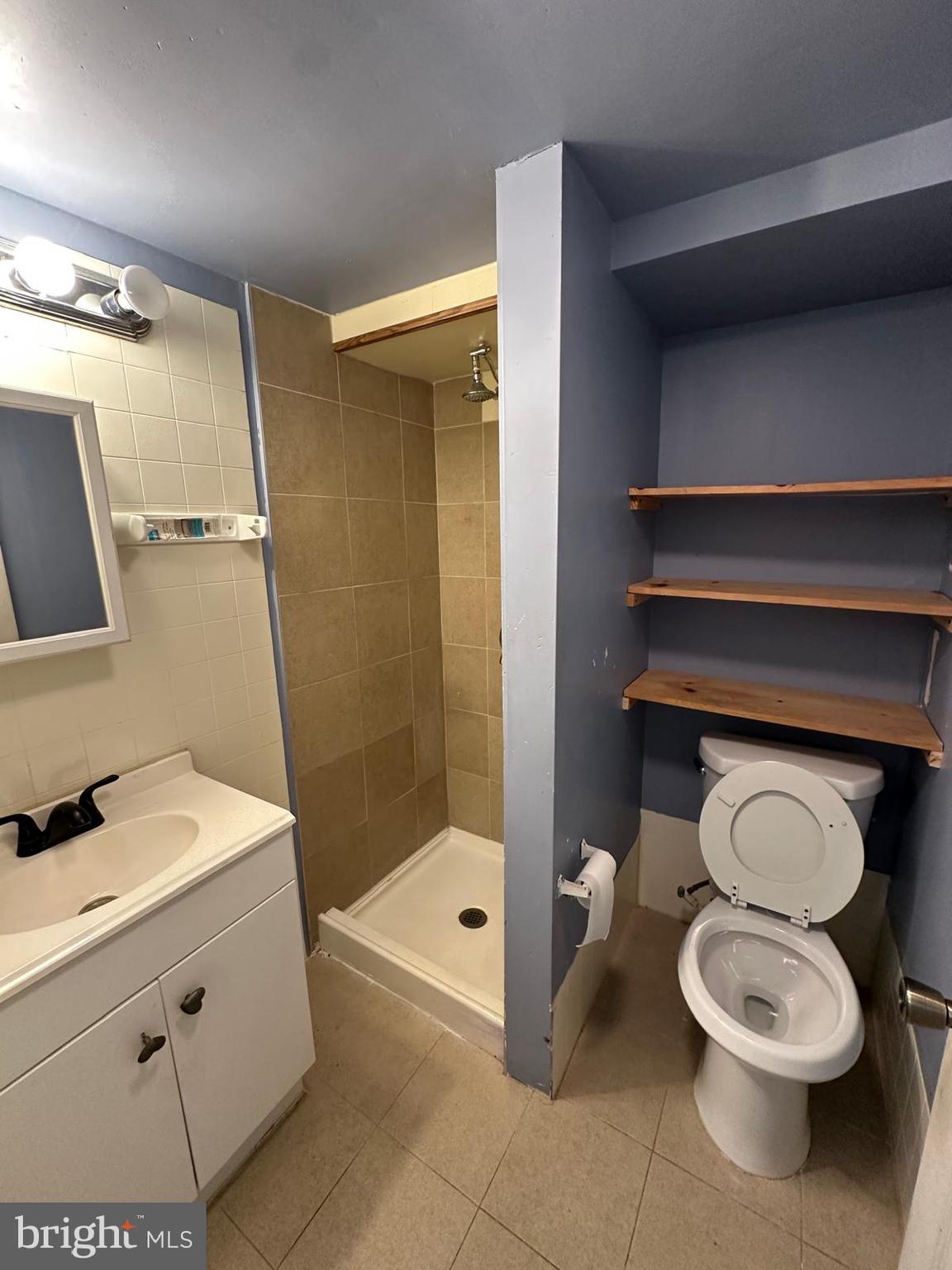 2114 Simon Street Philadelphia, PA 19124 - Photo 16 of 19 a bathroom with a toilet a sink and shower