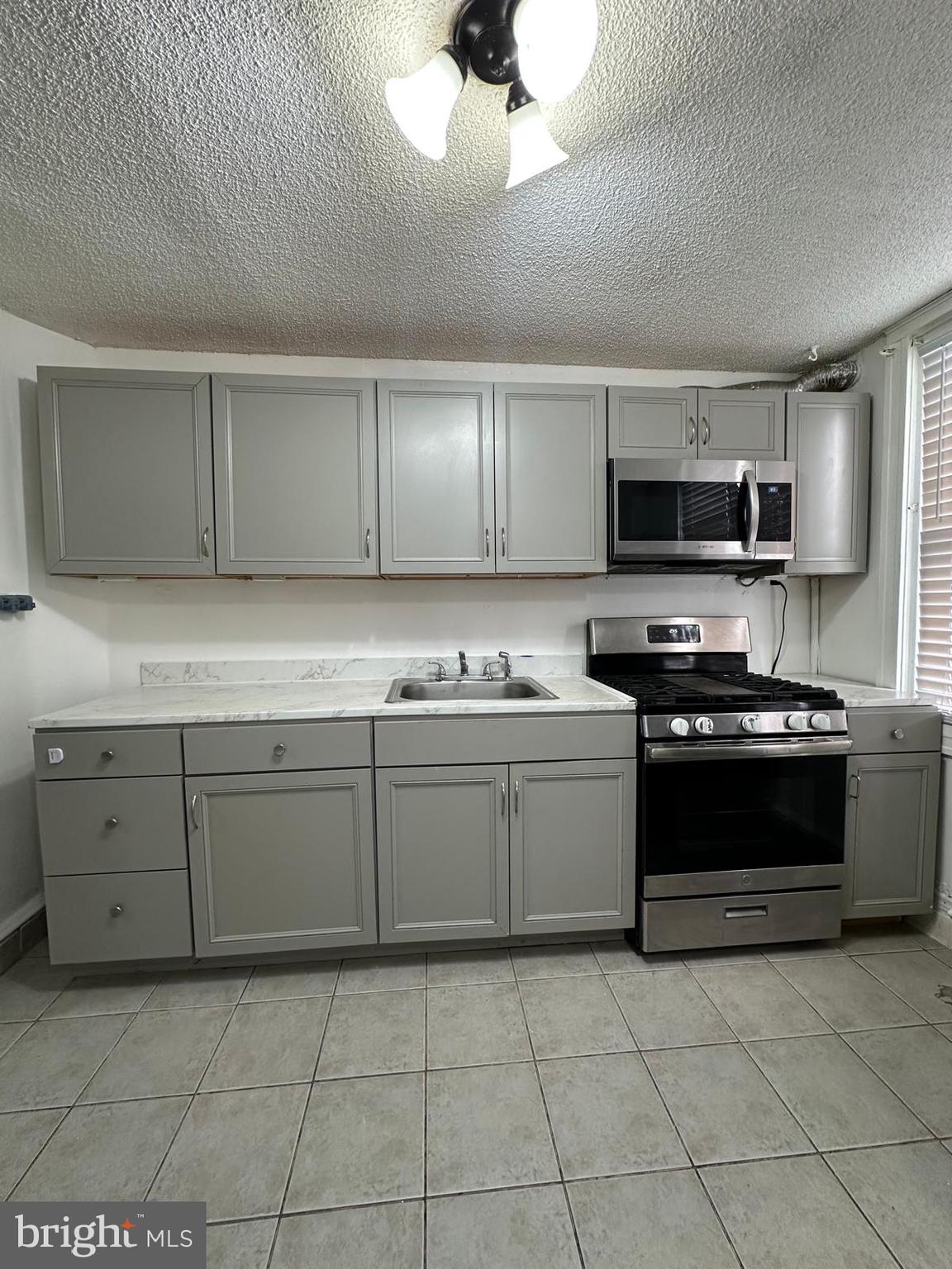 2114 Simon Street Philadelphia, PA 19124 - Photo 4 of 19 a kitchen with stainless steel appliances granite countertop a stove sink and cabinets