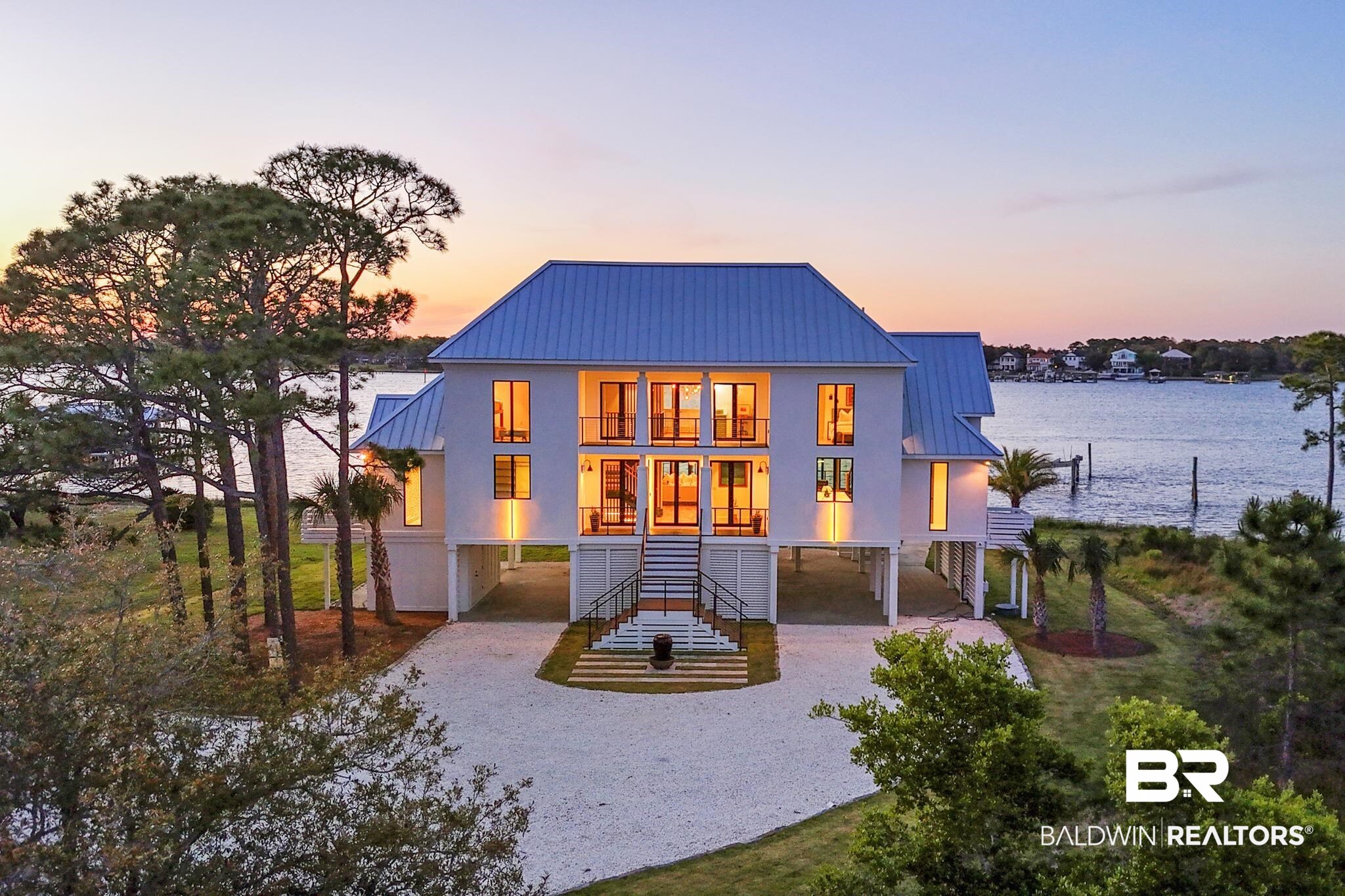 33349 River Road Orange Beach, AL 36561 - Photo 50 of 61 Waterfront residence featuring a blue metal roof, white exterior, and multiple balconies
