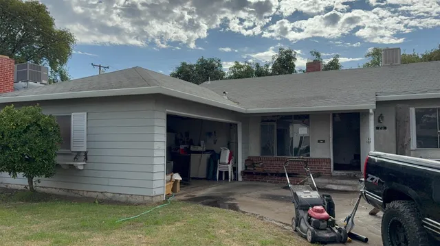 a view of a chair and table in front of house