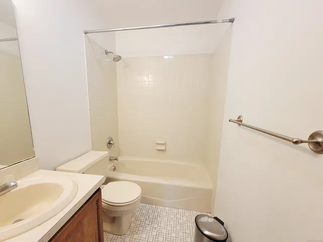 a bathroom with a sink a toilet and shower curtain