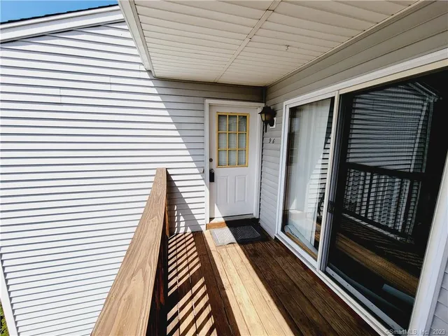 a view of a balcony with wooden floor