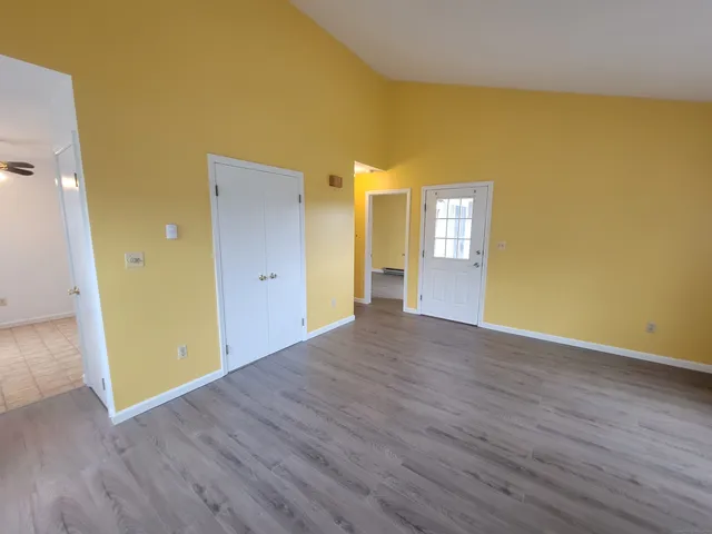 wooden floor in an empty room with a window