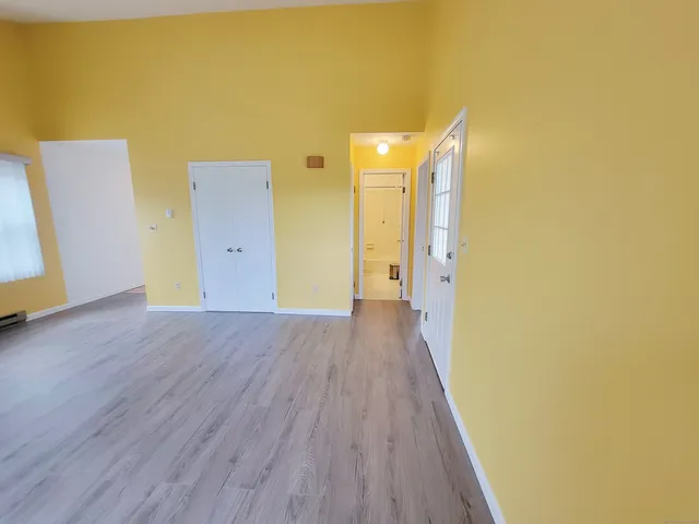 a view of a room with wooden floor