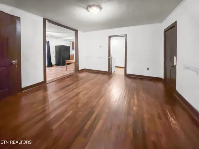 a view of a room with wooden floor and brick walls