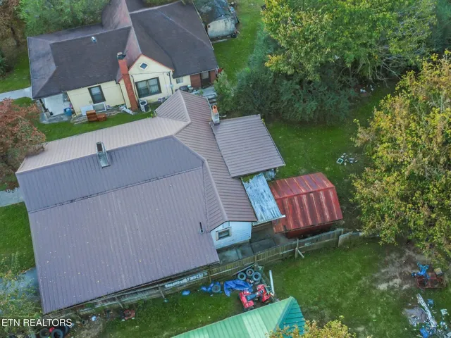 an aerial view of a house with garden space and street view