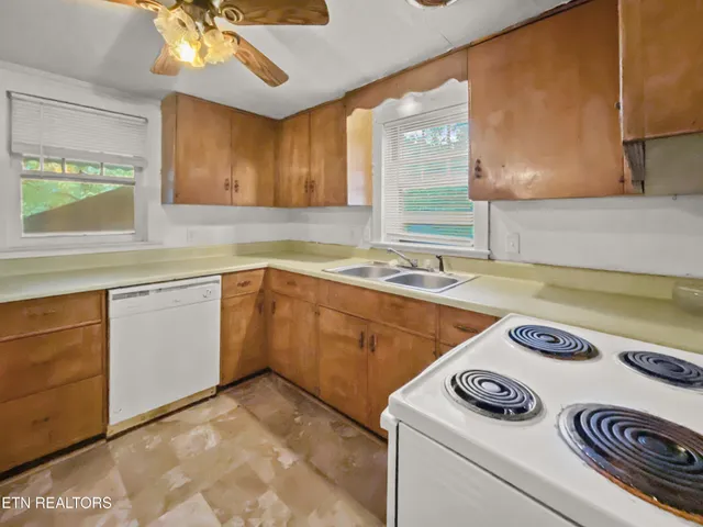 a kitchen with a sink a stove and cabinets