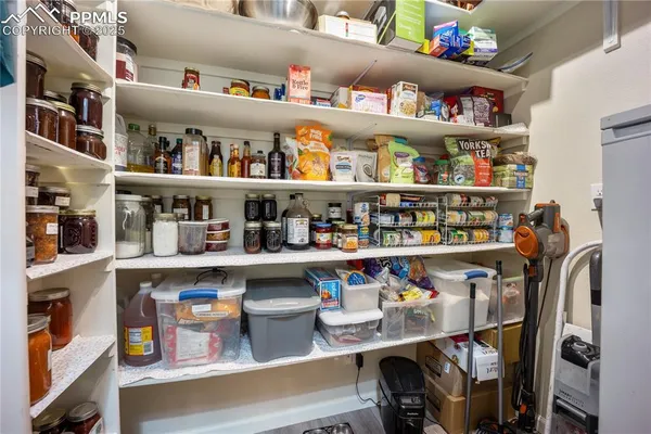 a shelf with cup and plates