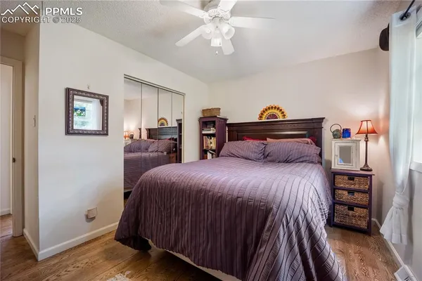 a bedroom with a bed and wooden floor