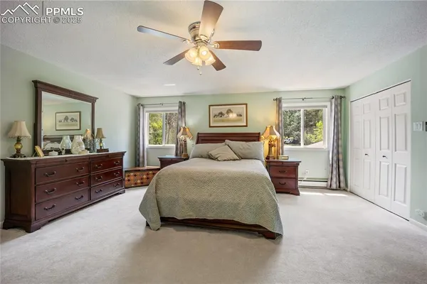 a spacious bedroom with a bed and a dresser