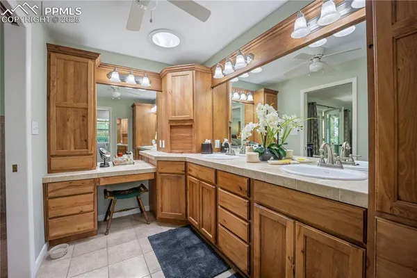 a large bathroom with a double vanity sink and a mirror