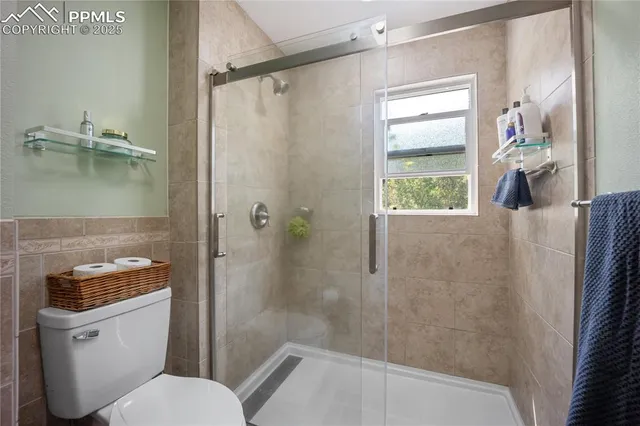 a white toilet sitting next to a bath tub shower