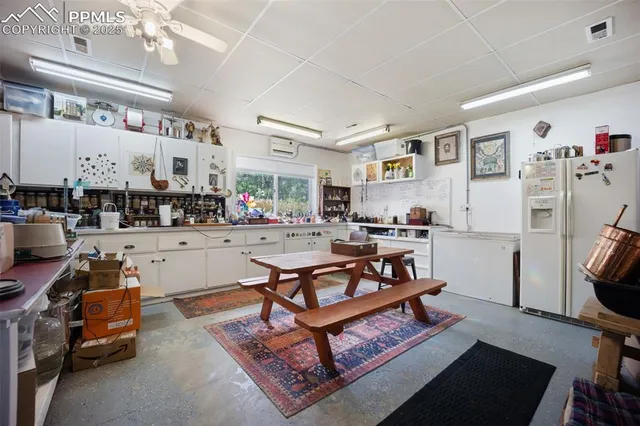 a room with furniture a rug and a floor to ceiling window