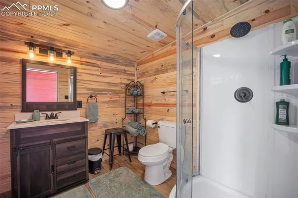 a kitchen with stainless steel appliances a large window a sink and wooden cabinets