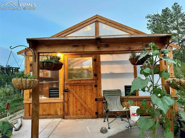 a patio with table and chairs under an umbrella