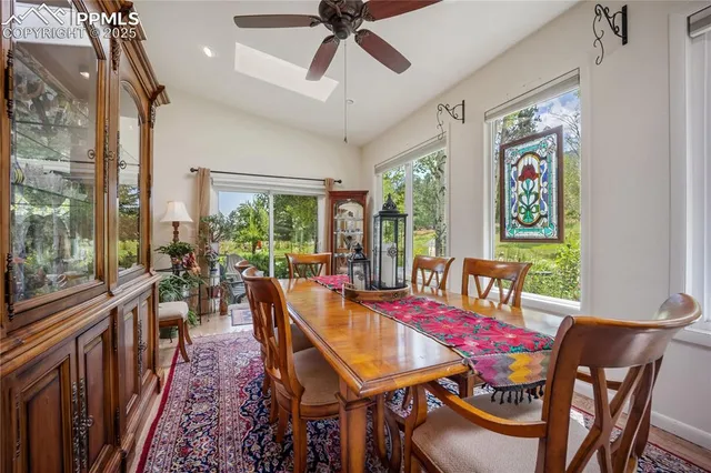 a dining room with furniture a rug and a chandelier