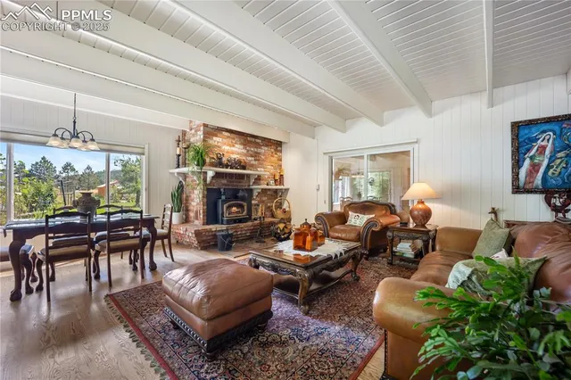 a living room with furniture fireplace and outdoor view