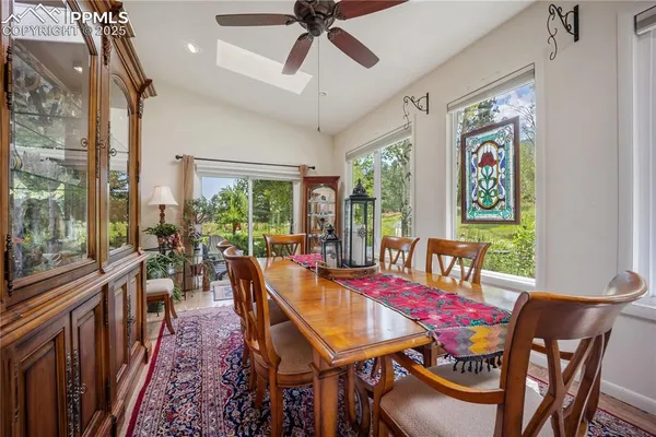 a dining room with furniture a rug and a chandelier