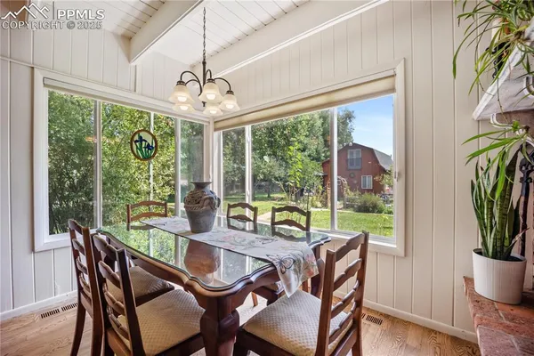 a dining room with furniture window and outside view
