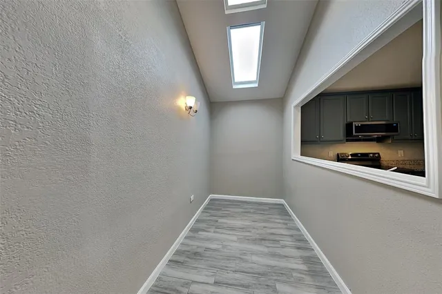 a view of a kitchen from the hallway