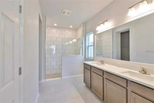 a bathroom with a shower sink and mirror