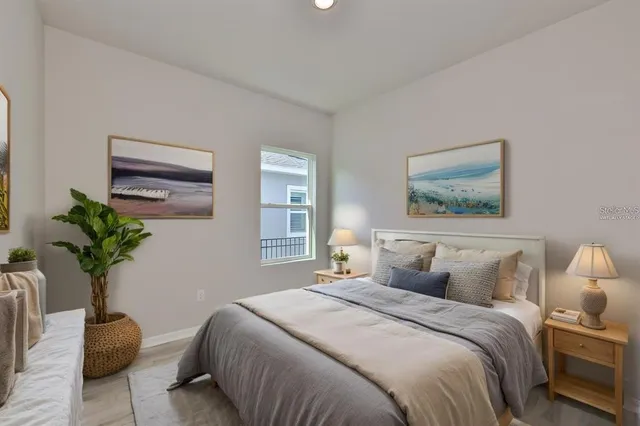 a bedroom with bed and a potted plant