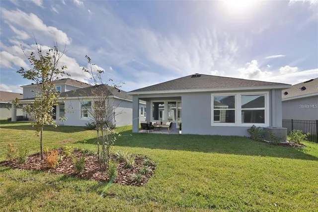 a front view of a house with a garden and yard