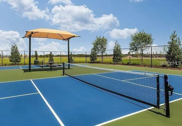 a view of a patio with table and chairs under an umbrella