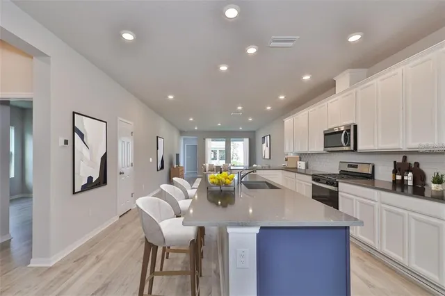 a kitchen with a counter top appliances and cabinets