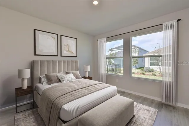 a bedroom with a bed and a large window