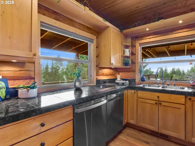a kitchen with stainless steel appliances granite countertop a sink a stove and cabinets