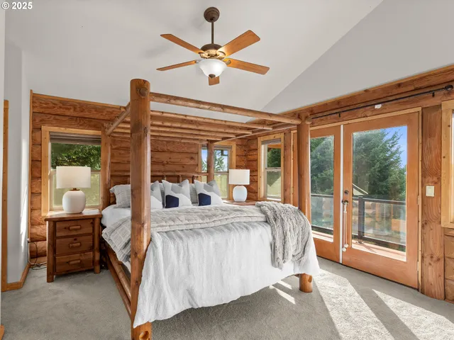 a bedroom with a bed and a large window